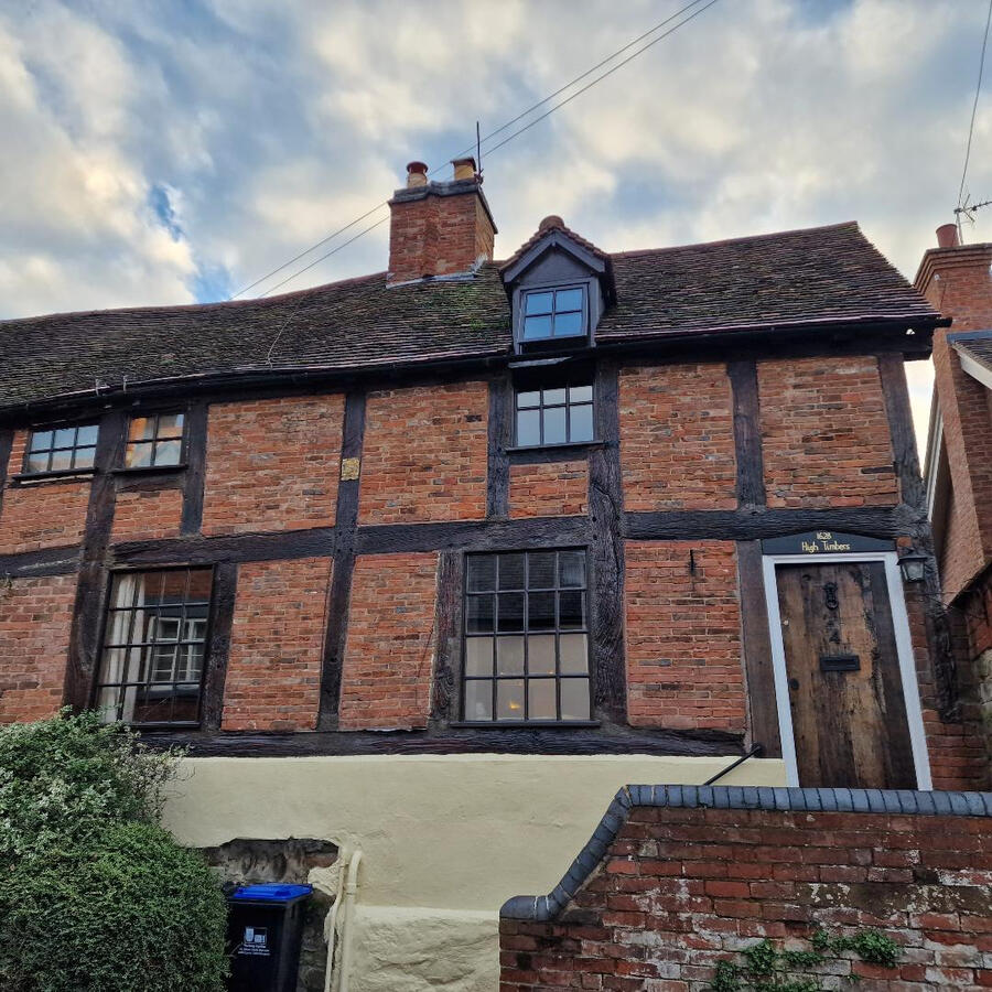 All beams renovated, windows and masonry painted; door treated and house name painted